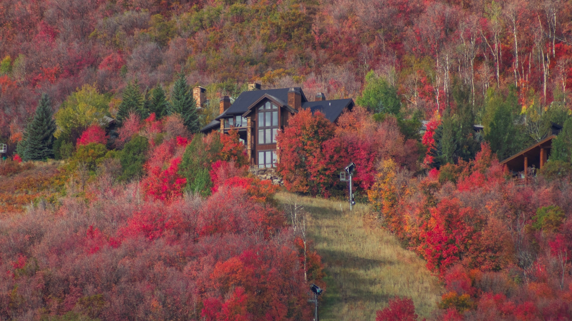 A far away image of a beautiful Park Meadows Utah home in the autumn.